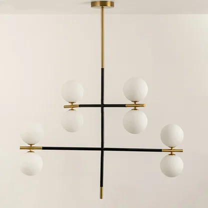 Frosted glass globe chandelier with gold accents and black metal frame designed for elegant modern ceiling lighting.
