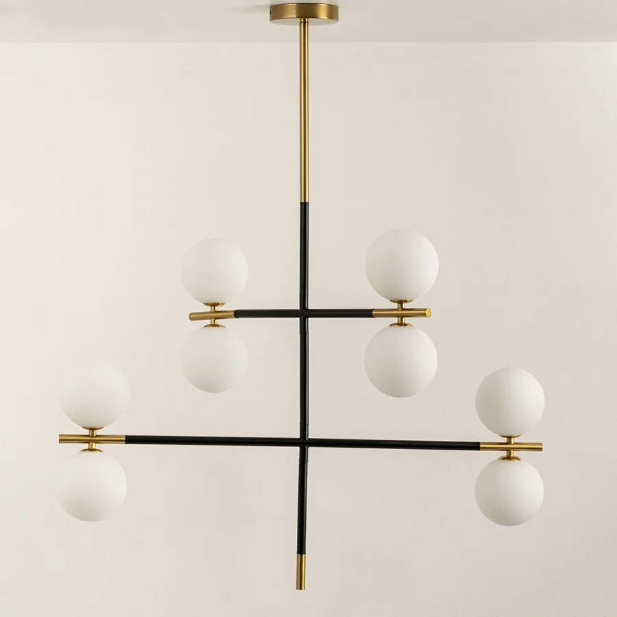 Frosted glass globe chandelier with gold accents and black metal frame designed for elegant modern ceiling lighting.