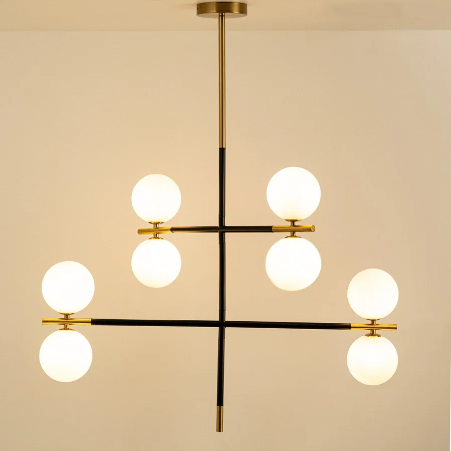Frosted glass globe chandelier with gold and black metal frame designed for elegant modern ceiling lighting indoors.