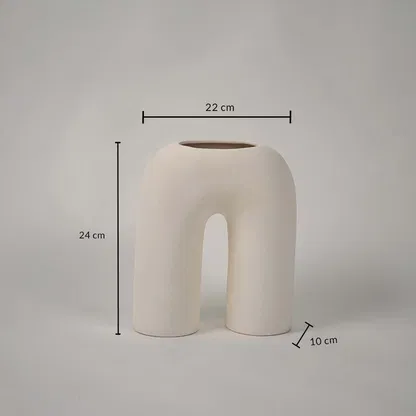 Cream ceramic arch vase with sculpted modern form shown with dimensions of 22 cm width 24 cm height and 10 cm depth ideal for shelves consoles or centerpieces.