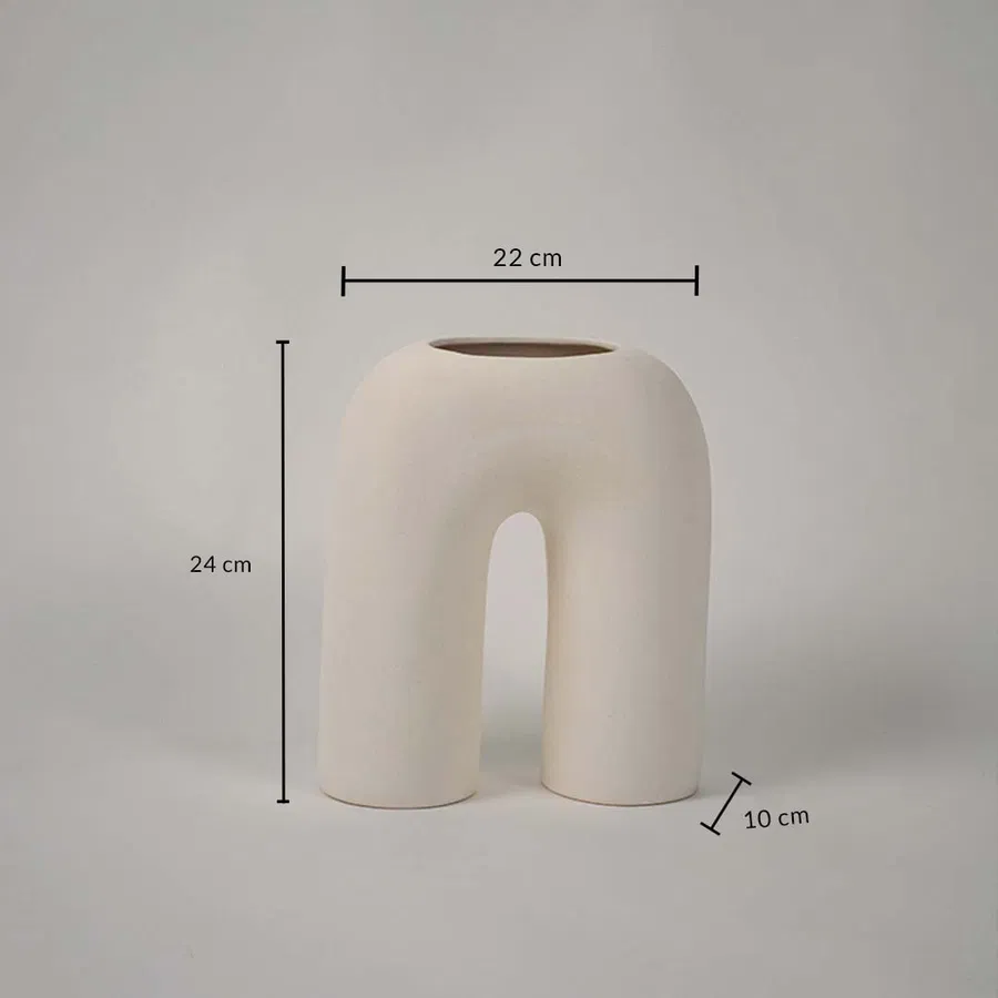 Cream ceramic arch vase with sculpted modern form shown with dimensions of 22 cm width 24 cm height and 10 cm depth ideal for shelves consoles or centerpieces.