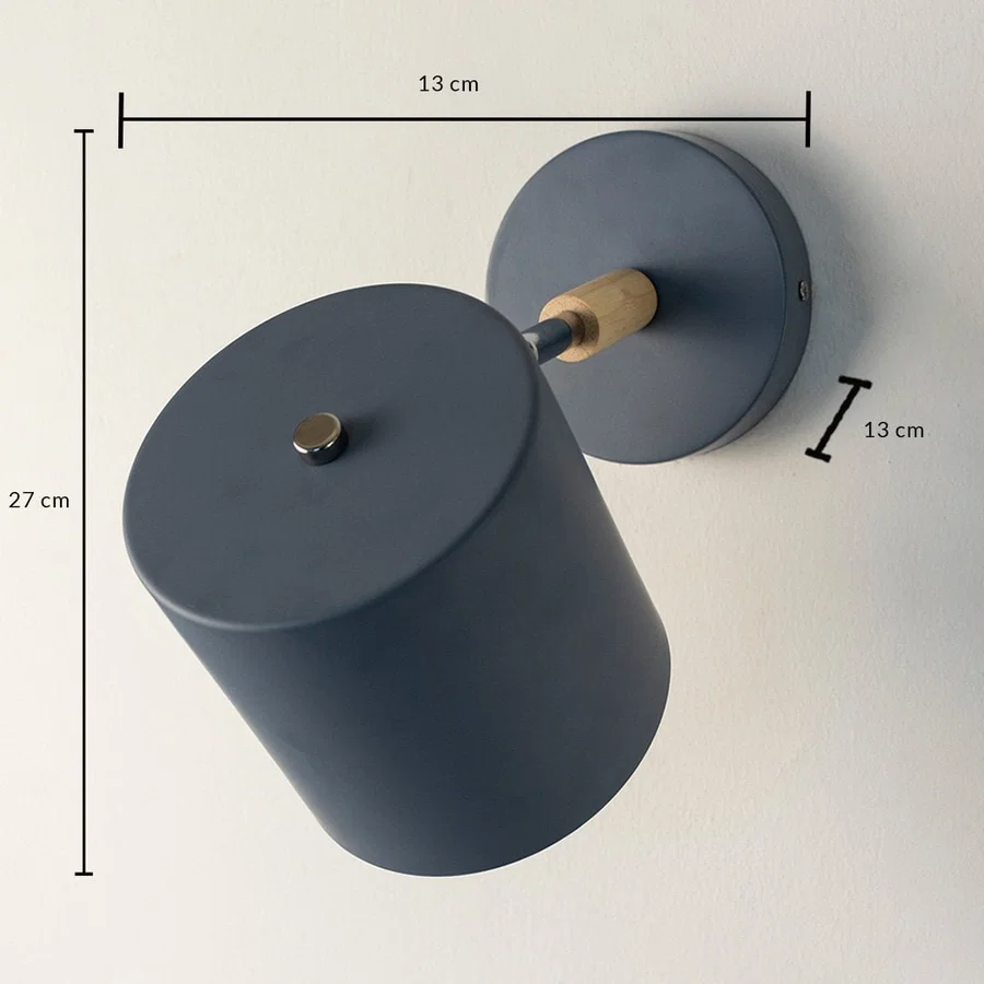 A blue wall lamp on white background with clear measurements showing height 27 cm width 13 cm and wall plate diameter 13 cm along with the angled shade and wooden connector.