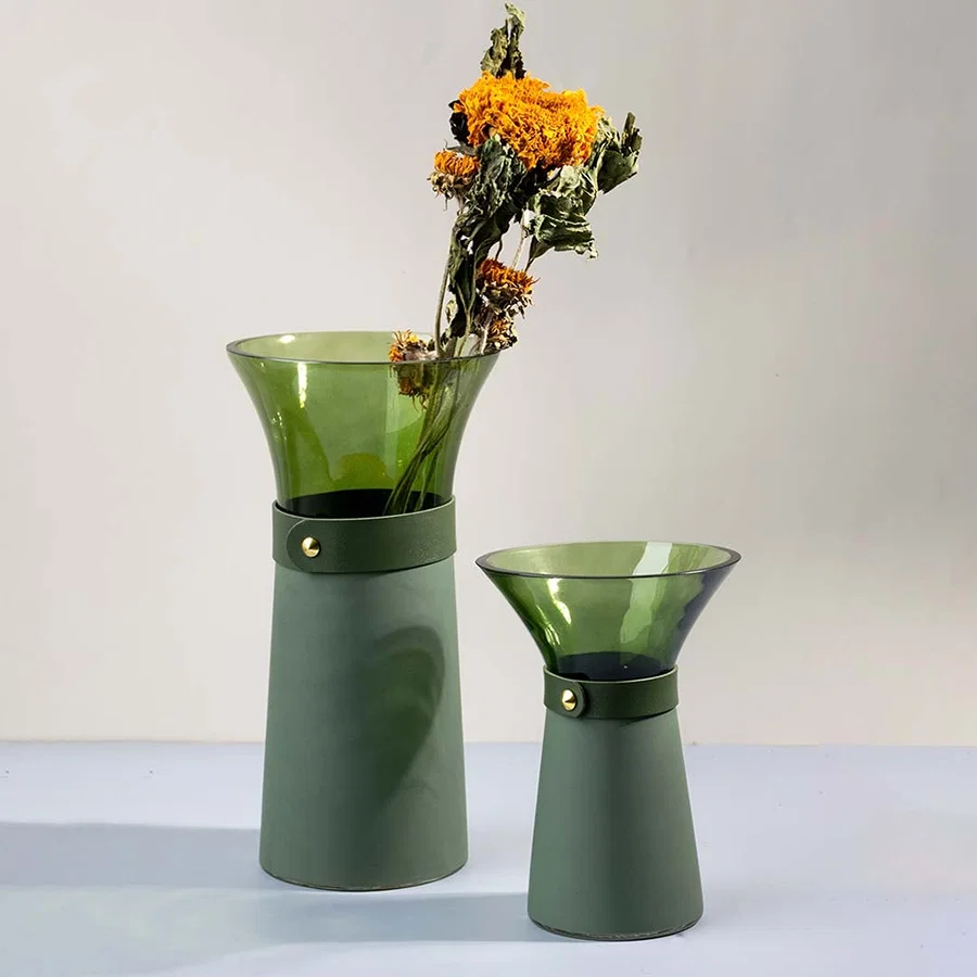 Set of green glass vases styled together as chic tabletop accents for modern and minimal decorative interiors.