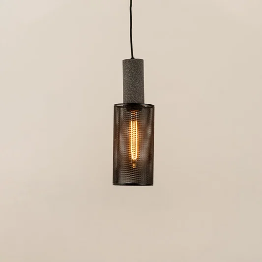Smoky ribbed glass pendant light with black metal frame creating warm ambient glow for modern interiors.