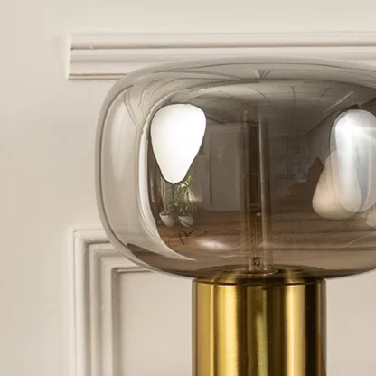 Halo closeup showing golden base and smoked glass dome shade designed for modern decorative table lamp home lighting setup.