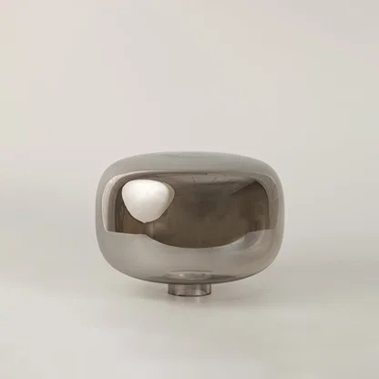Halo glass table lamp with golden base and dome shade displayed on white background with light turned on for interiors.