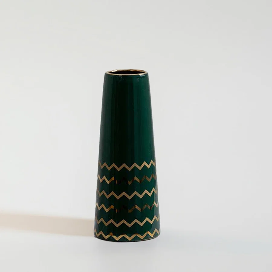 Dark green ceramic decorative vase with gold zigzag pattern for shelf styling and contemporary home decor displays.