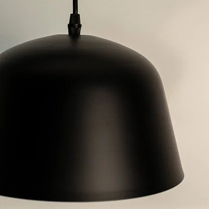 Black metal dome pendant light with smooth finish crafted for modern kitchens and dining spaces.
