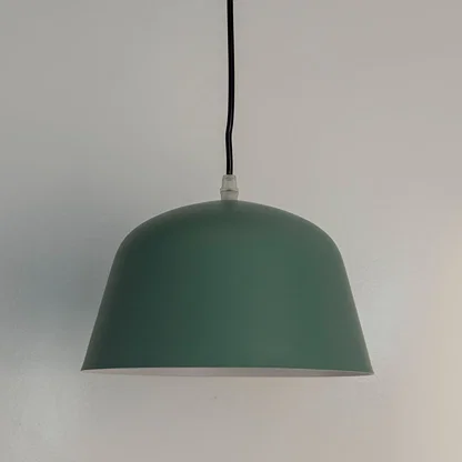 Green metal pendant light with minimalist dome shade designed for contemporary living and dining interiors.