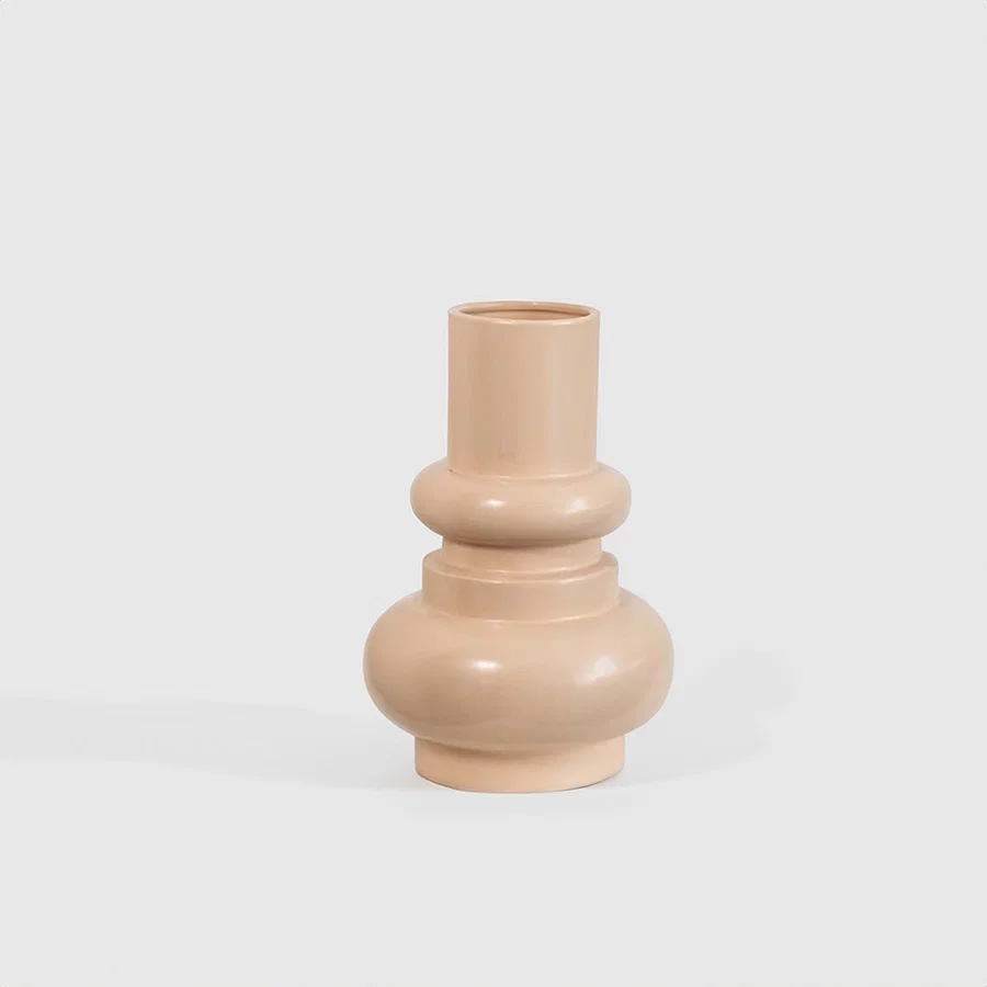 Matte peach terracotta ceramic vase featuring a tiered ring collar and a bulbous base profile on a white background.
