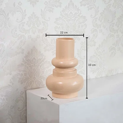 Peach sculptural vase dimension display showing height 33 cm  width 22 cm  and base depth 20 cm against a minimal white background.
