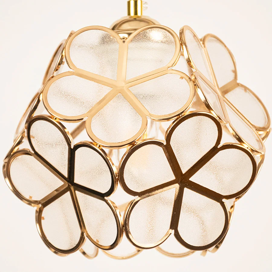 Gold metal geometric pendant light closeup showcasing artistic frame for luxurious modern ceiling lighting decor.
