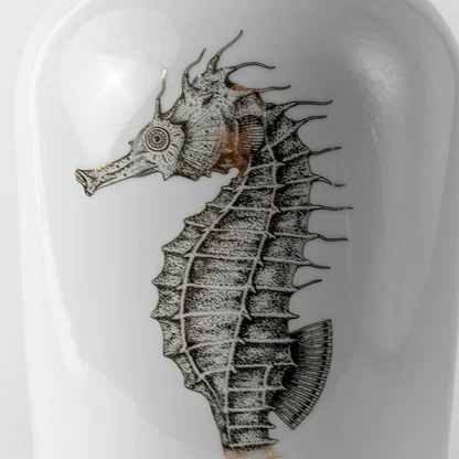 Grey ceramic vase with detailed seahorse illustration displayed in a closeup view highlighting textured strokes artistic shading and modern nautical décor for stylish contemporary homes.