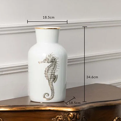 White ceramic jar with silver seahorse design measuring 18.5 cm width and 29.5 cm height ideal for coastal décor themes and elegant console styling.