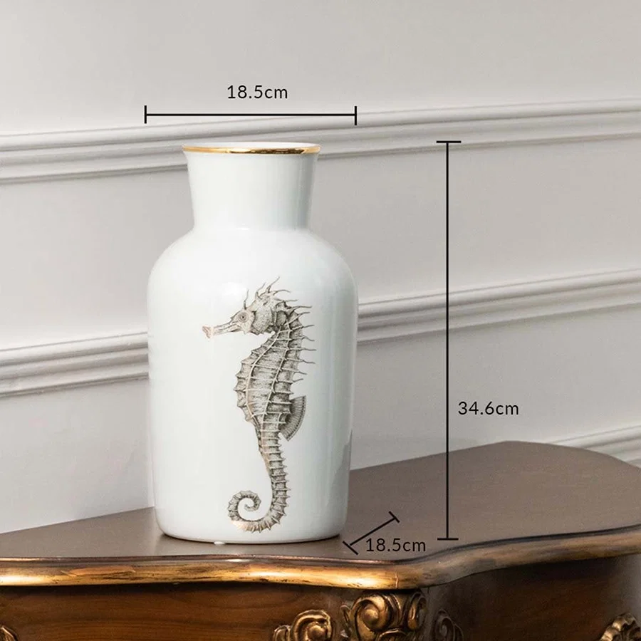 White ceramic jar with silver seahorse design measuring 18.5 cm width and 29.5 cm height ideal for coastal décor themes and elegant console styling.