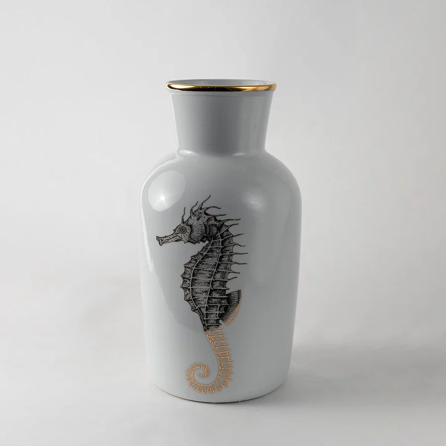 White ceramic decorative vase with black seahorse artwork for elegant shelf styling and contemporary home decor displays.