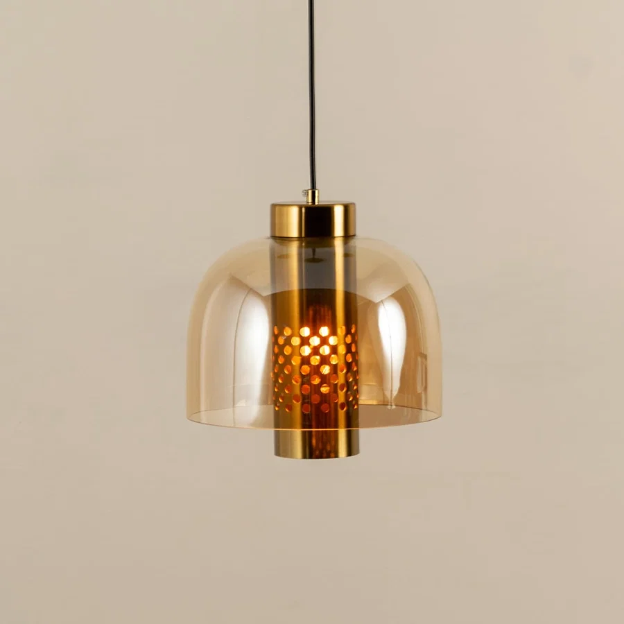 Elegant amber glass pendant light with gold metal finish for stylish kitchen and dining room decor styling.