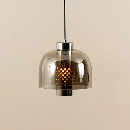 Smoke glass pendant light illuminated to display elegant ceiling lighting with contemporary decorative appeal.