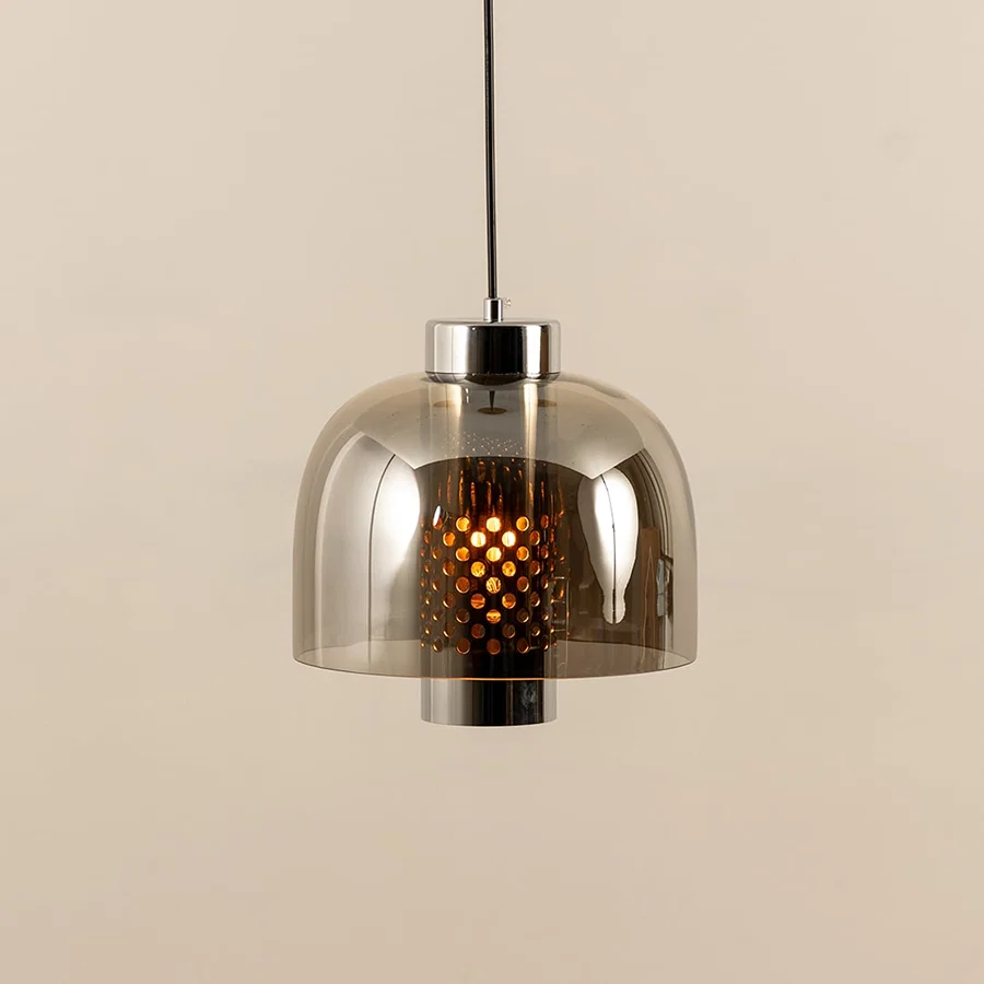 Smoke glass pendant light illuminated to display elegant ceiling lighting with contemporary decorative appeal.