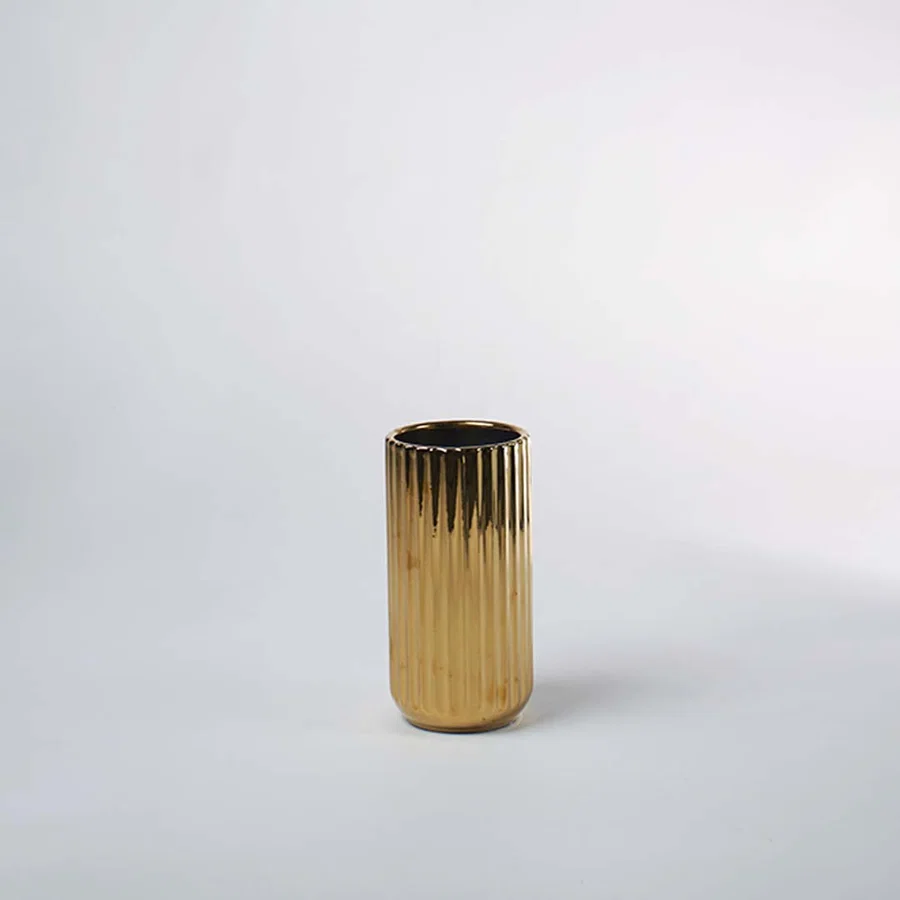 Gold textured metal planter pot with cylindrical silhouette for elegant indoor plant styling and luxury decor.