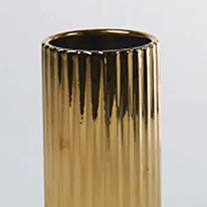 A detailed view of a gold ribbed vase capturing its glossy texture and refined finish creating a closeup look that enhances its elegant modern style.