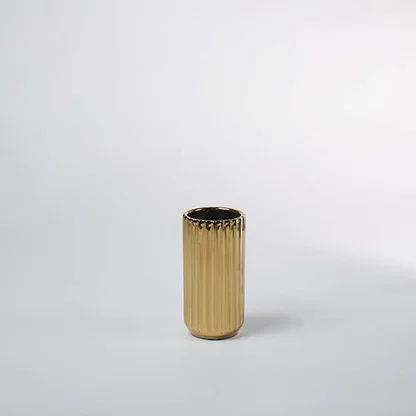 Gold metal decorative planter pot with ribbed texture for contemporary tabletop plant styling and home decor.