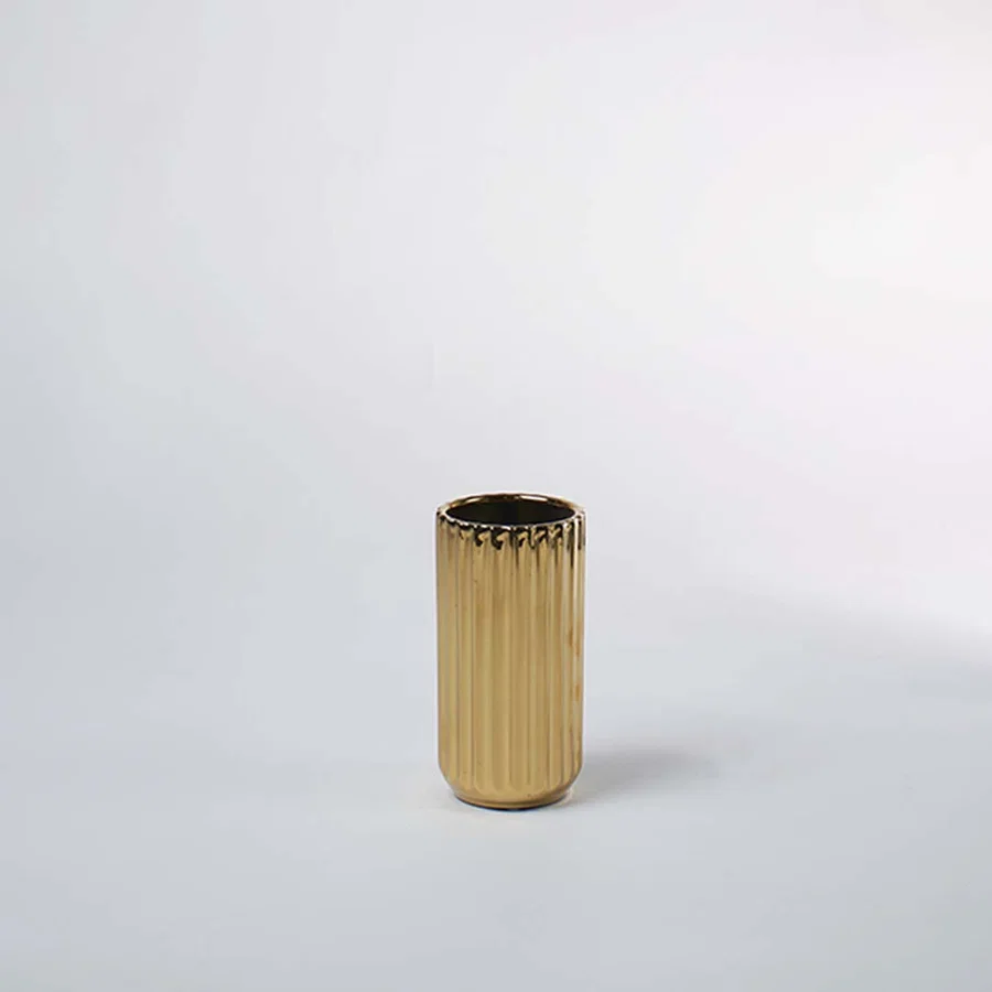 Gold metal decorative planter pot with ribbed texture for contemporary tabletop plant styling and home decor.