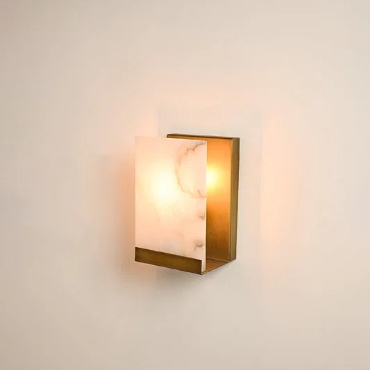 Rectangular metal wall sconce illuminated on white background featuring alabaster texture and warm glow perfect for refined and elegant interiors.