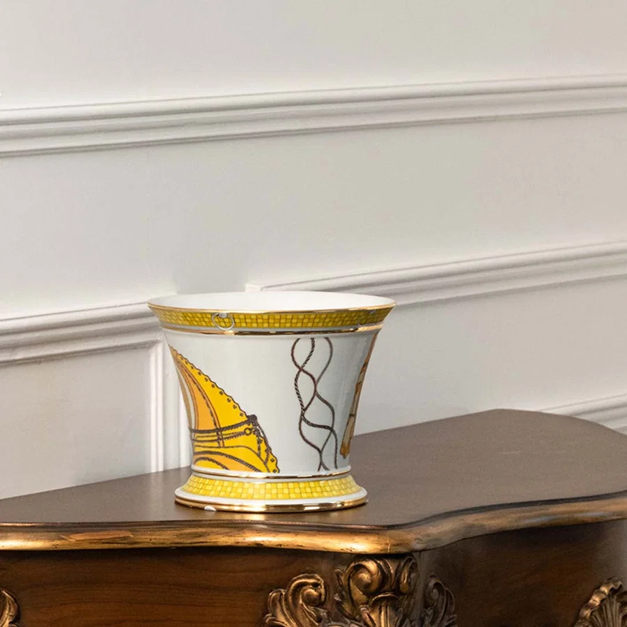 White ceramic decorative jar with gold abstract artwork displayed on a console table for luxury home decor styling.