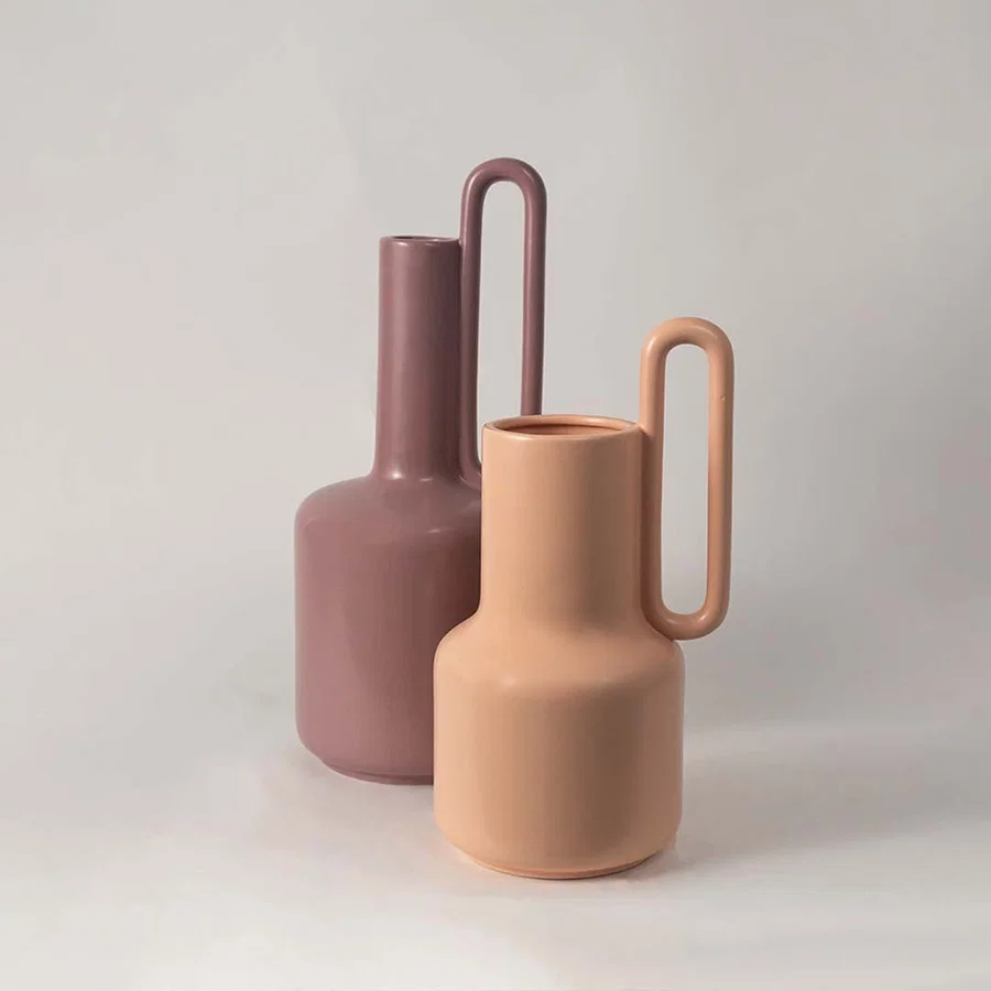 Grouped display of the ribbed white ceramic vase showing its modern form and textured finish in a clean  minimal arrangement.