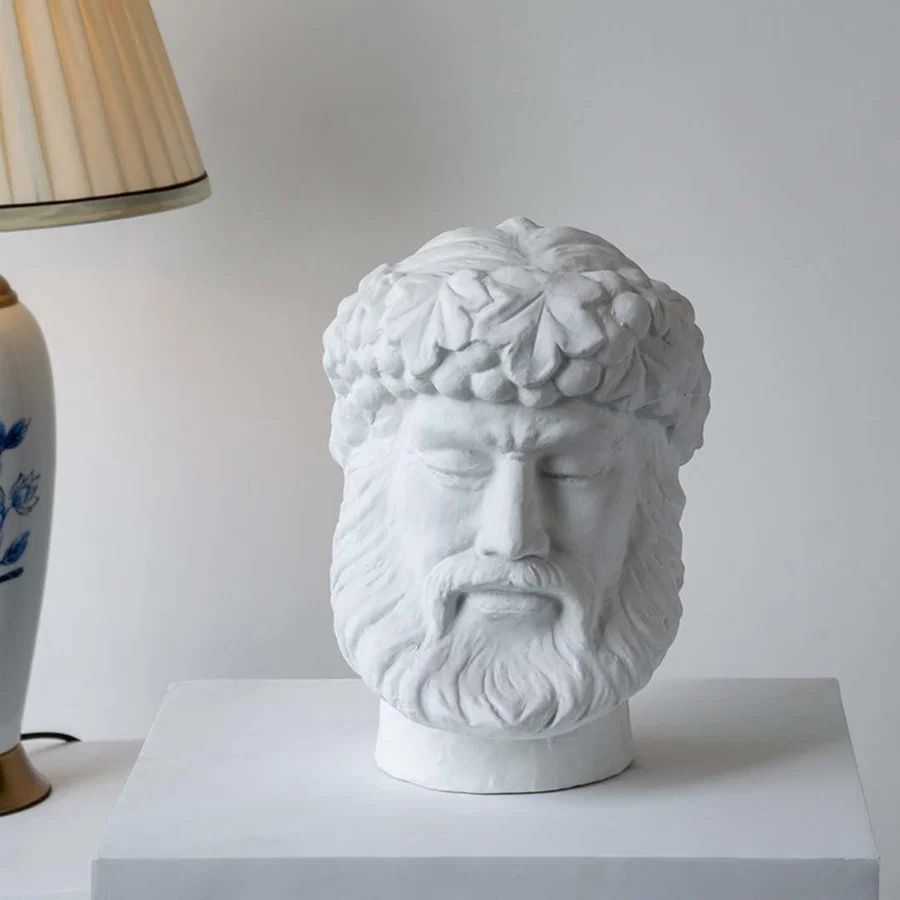 White sculpted head décor piece in a front view ideal for artistic décor styling and modern pedestal display.