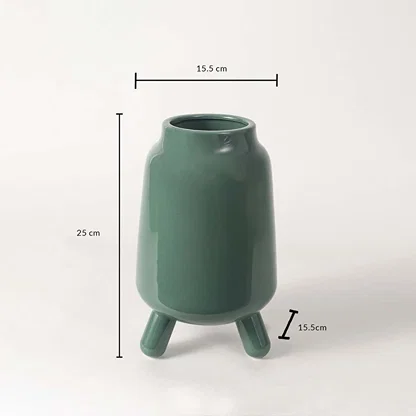 A green tripod ceramic vase shown with measurements displaying 25 cm height 15.5 cm width and 15.5 cm base distance for accurate size reference.