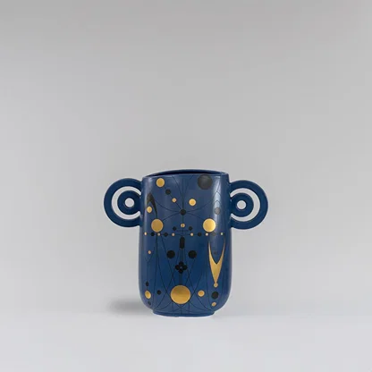 Navy blue ceramic vase with abstract gold detailing and loop handles displayed on a clean white background for modern decor styling.
