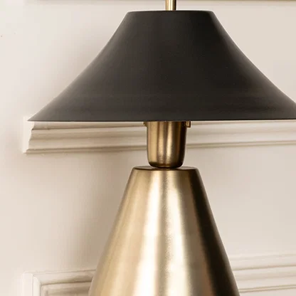 Closeup of black shade and gold base showcasing sleek craftsmanship and refined metallic texture ideal for modern luxury lighting decor.