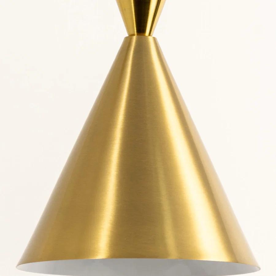 Closeup of brushed gold metal pendant light shade for elegant kitchen island and dining room decor styling.