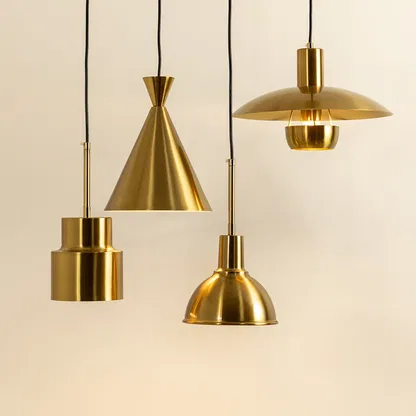 Gold metal pendant lights illuminated to display premium decorative ceiling lighting with contemporary design appeal.