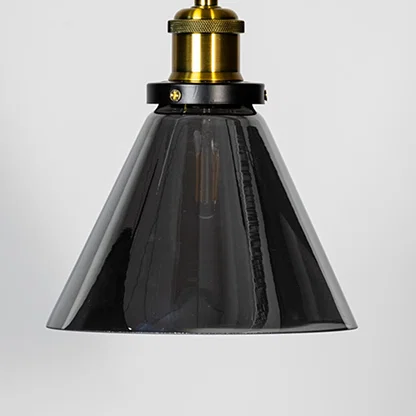 Smoked glass cone pendant light with brass metal fixture showcasing glossy finish and modern lighting style.