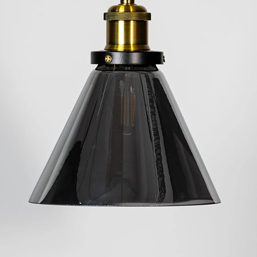 Smoked glass cone pendant light with brass metal fixture showcasing glossy finish and modern lighting style.