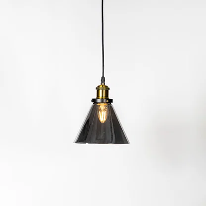 Smoked glass cone pendant light with brass metal holder and contemporary design for elegant ceiling lighting decor.
