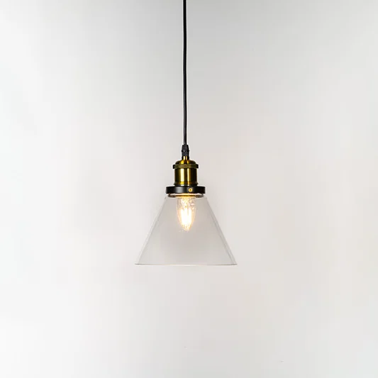 Amber glass globe pendant light illuminated with warm glow and brass metal accents for stylish ceiling lighting decor.