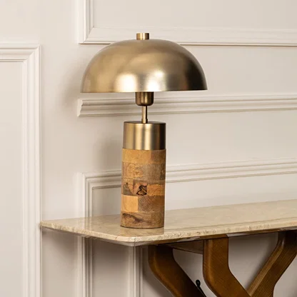 Minimalist dome table lamp in brushed gold and wood finish standing gracefully even when unlit making it a timeless piece for modern decor styling.