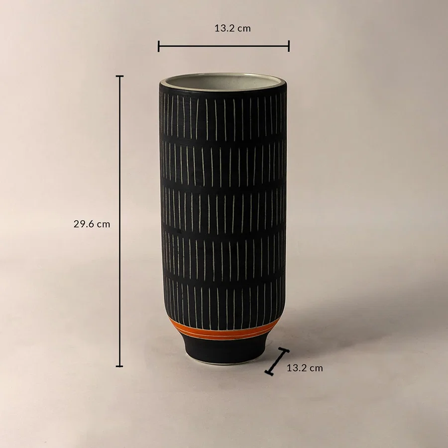 Black ceramic vase with white striped design and orange accent shown with 29.6 cm height and 13.2 cm diameter dimensions.