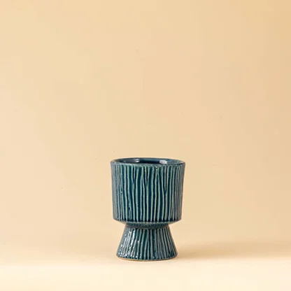 Blue ceramic decorative vase with sculptural textured silhouette for elegant shelf styling and modern home decor.
