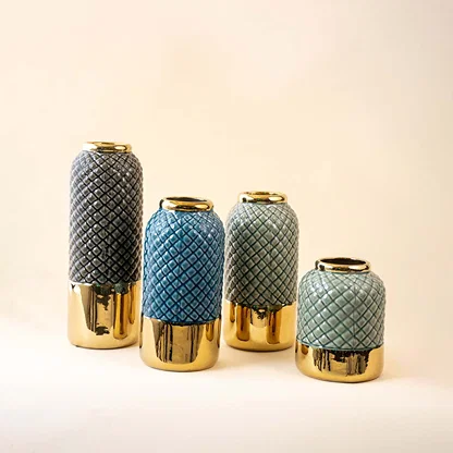 Set of blue and grey ceramic decorative vases with gold bases for luxury shelf styling and modern home decor.