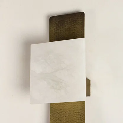 Modern marble and gold wall light for stylish bedroom and contemporary decor styling spaces.

