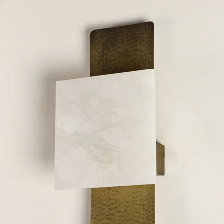 Modern marble and gold wall light for stylish bedroom and contemporary decor styling spaces.

