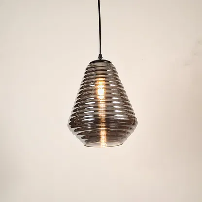 Smoked ribbed glass pendant light with modern design and exposed bulb for elegant ceiling lighting in living spaces.