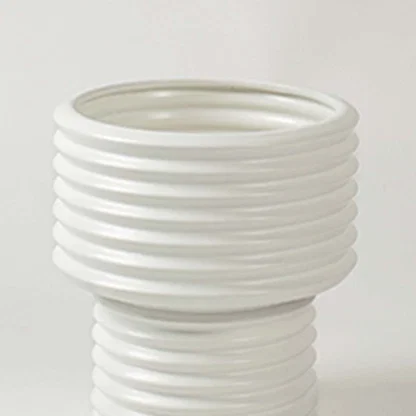 Closeup of white ribbed ceramic vase showing its smooth glossy finish and textured detailing ideal for modern home styling.
