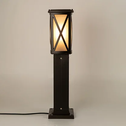 Modern black outdoor bollard light with warm glowing panels for elegant exterior decor styling use.