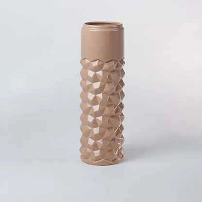 Peach ceramic decorative vase with bubble texture and tall silhouette for contemporary shelf styling and home decor.